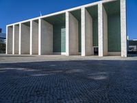 a view of a very nice building that looks like a large hall or room with columns