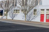 a stop sign is placed on the corner of a street next to a tall building