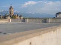 several large empty parking spaces in the city with buildings nearby in front of them -