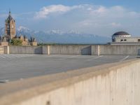 several large empty parking spaces in the city with buildings nearby in front of them -