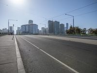 a car driving on an empty highway in a city skyline setting over the ocean side