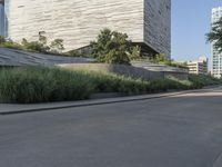 there is a woman riding a bike on the sidewalk in front of an urban building