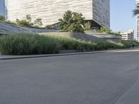 there is a woman riding a bike on the sidewalk in front of an urban building