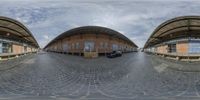 this fisheye view shows an exterior and car park with cobblestones in the foreground