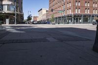 street view of downtown building with busy street intersection in background on sunny day with clear sky