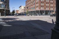 street view of downtown building with busy street intersection in background on sunny day with clear sky