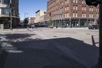 street view of downtown building with busy street intersection in background on sunny day with clear sky