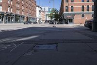 street view of downtown building with busy street intersection in background on sunny day with clear sky