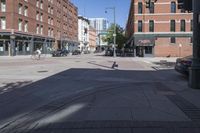 street view of downtown building with busy street intersection in background on sunny day with clear sky