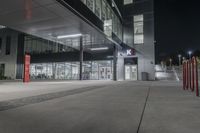 this is an image of the exterior of a building at night with traffic cones lined around