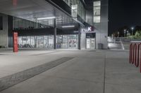 this is an image of the exterior of a building at night with traffic cones lined around