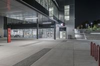 this is an image of the exterior of a building at night with traffic cones lined around