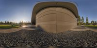 an spherical view of a building with lots of cement on the sides of it and a few trees in the middle