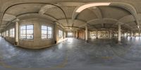 a fish eye view of a concrete office building with multiple windows and arches and an arched ceiling