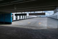 an empty parking garage with a train sitting in it's compartment and waiting people to board