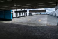 an empty parking garage with a train sitting in it's compartment and waiting people to board