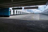 an empty parking garage with a train sitting in it's compartment and waiting people to board