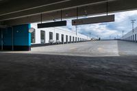 an empty parking garage with a train sitting in it's compartment and waiting people to board