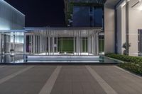 a building with a light at night in front of it, and there is an open area with a courtyard