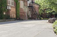 a large brick building with stairs going up the front of it to another building in front of it