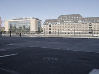 the city is next to an empty riverbed in a parking lot with a few buildings