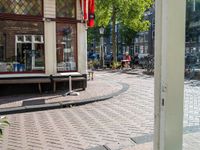 a dog sleeping on a bench in the street next to a bench next to buildings