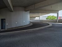 a car is driving on the highway through an underground parking garage area in a city