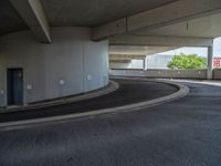 a car is driving on the highway through an underground parking garage area in a city