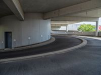 a car is driving on the highway through an underground parking garage area in a city