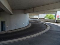 a car is driving on the highway through an underground parking garage area in a city