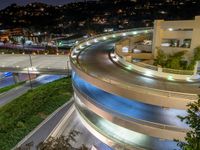 a view of a road and an overpass with traffic passing through it by buildings