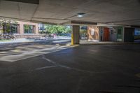 a person walks down an empty parking lot where no cars are parked, and there is the sun peeking over it