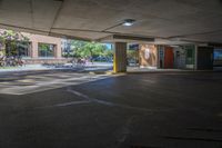 a person walks down an empty parking lot where no cars are parked, and there is the sun peeking over it