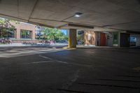 a person walks down an empty parking lot where no cars are parked, and there is the sun peeking over it