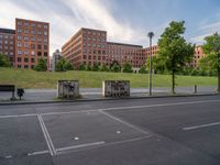 there is a lot of parking spaces along the street that are empty of cars, and many buildings behind them