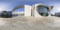 this is a circular shot taken through a fisheye lens of a building and river