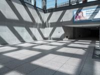 shadow from the sun on a building wall and walkway with a sign that reads,'this place is a hospital in america