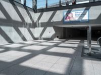 shadow from the sun on a building wall and walkway with a sign that reads,'this place is a hospital in america