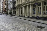 the pavement between a brick and stone street in a city that has stairs down the side