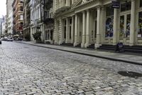 the pavement between a brick and stone street in a city that has stairs down the side