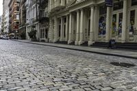 the pavement between a brick and stone street in a city that has stairs down the side