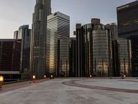 people walk near a deserted parking lot in a cityscape at dusk with some buildings