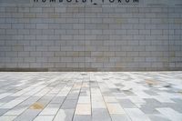 a man riding a skateboard in front of a wall with a word humsodi forum