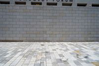 a man riding a skateboard in front of a wall with a word humsodi forum