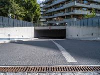 a city street with a very long metal walkway and several buildings behind it at the corner of it