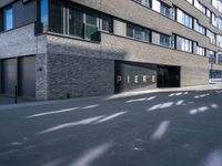 a black paved parking lot near an apartment building with the word perse on it