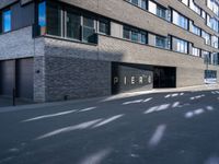 a black paved parking lot near an apartment building with the word perse on it