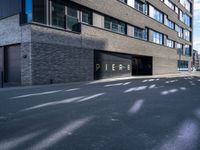 a black paved parking lot near an apartment building with the word perse on it