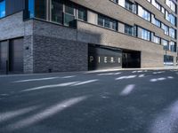 a black paved parking lot near an apartment building with the word perse on it