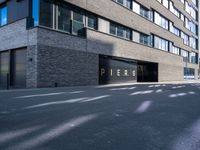 a black paved parking lot near an apartment building with the word perse on it